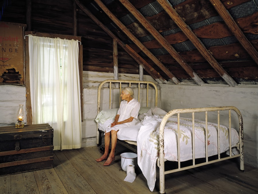 A cozy log bedroom under timber rafters, an iron bedstead by a curtained window
